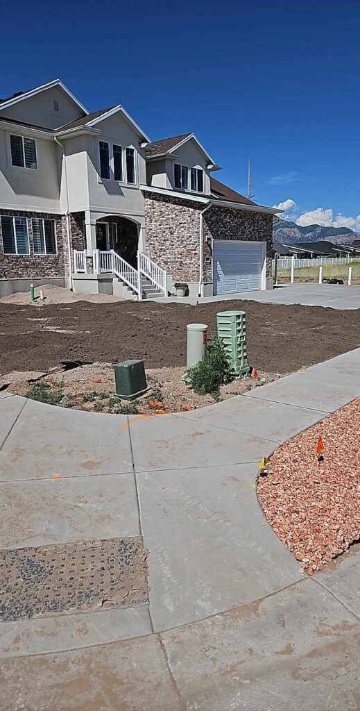 Large home with dirt and rocks in yard