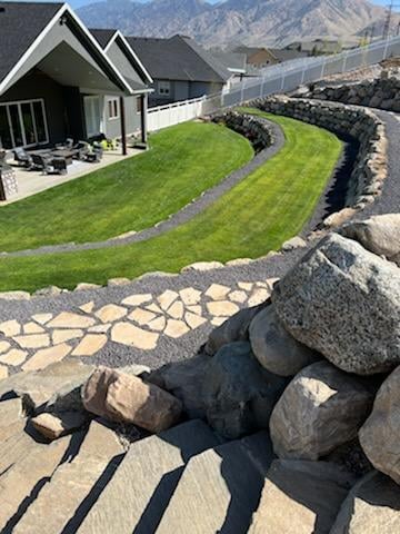 Series of terraces including grass, pavers, and rocks