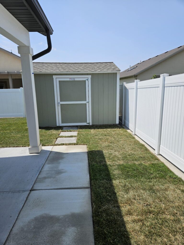 Yard with cement patio, shed, and freshly laid sod